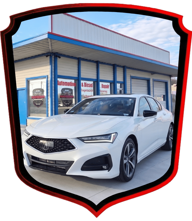 White Acura sedan parked outside WrenchWerks automotive repair shop