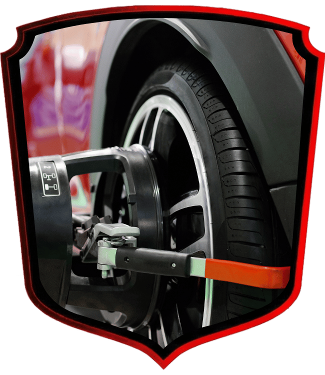 Wheel alignment service being performed on vehicle tire