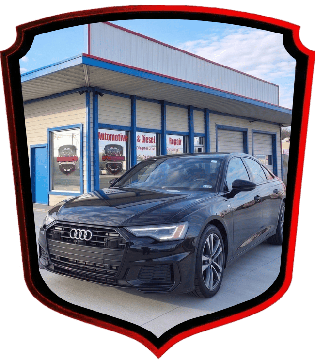 Black Audi luxury sedan parked in front of WrenchWerks repair facility