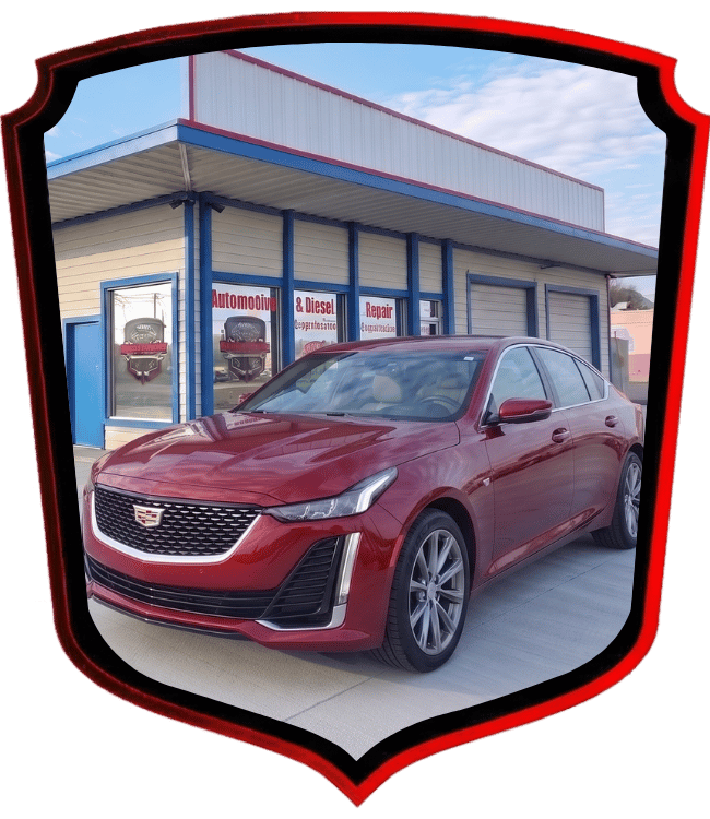 Red Cadillac luxury sedan parked outside WrenchWerks automotive repair shop