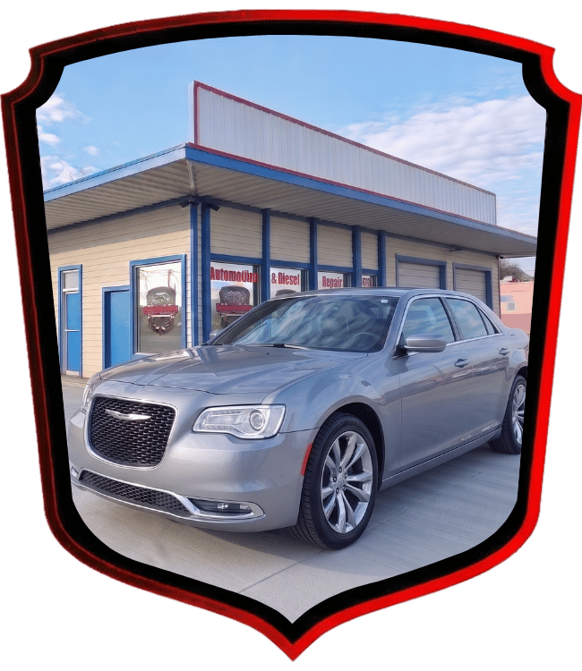 Silver Chrysler 300 sedan parked outside WrenchWerks repair shop