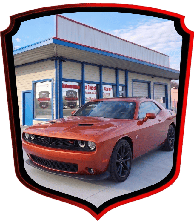 Orange Dodge Challenger muscle car outside WrenchWerks automotive repair shop