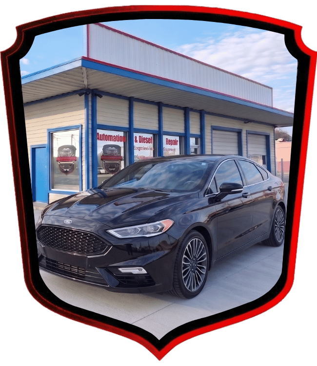 Black Ford Fusion sedan parked outside WrenchWerks auto repair facility