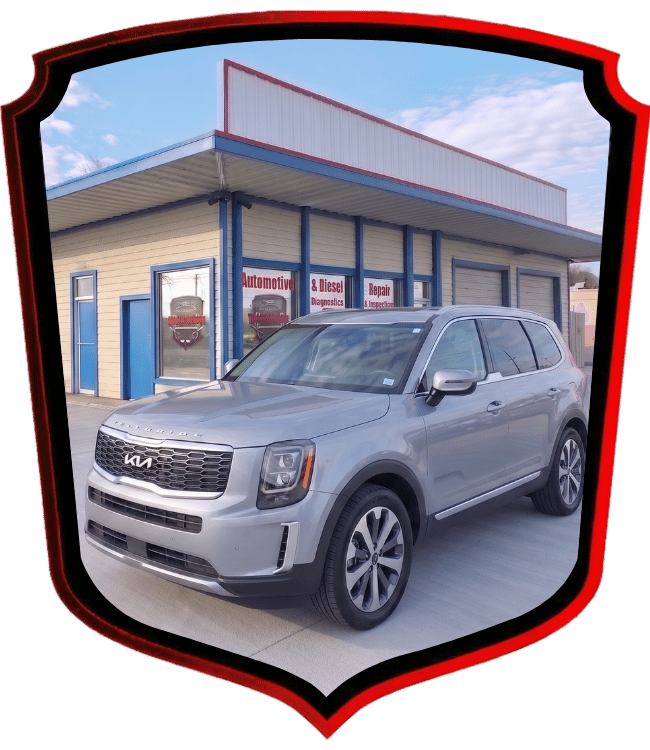 Silver Kia Telluride SUV parked outside WrenchWerks automotive repair shop