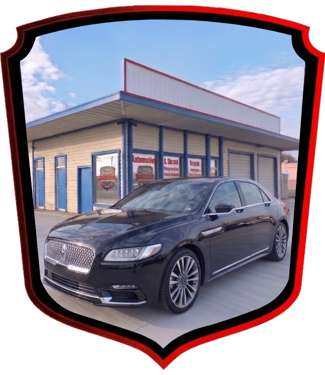 Black Lincoln luxury sedan parked outside WrenchWerks repair shop