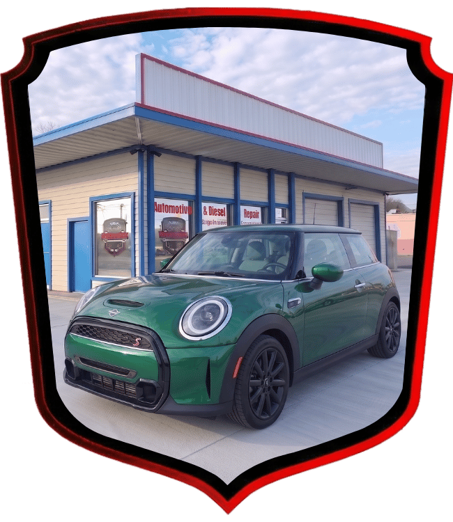Green MINI Cooper hatchback parked outside WrenchWerks automotive repair facility