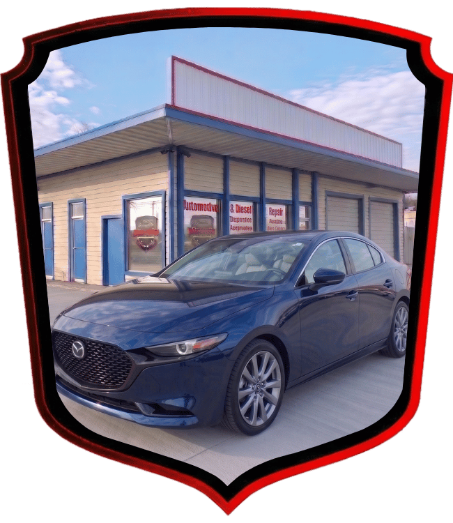 Blue Mazda sedan parked outside WrenchWerks automotive and diesel repair shop