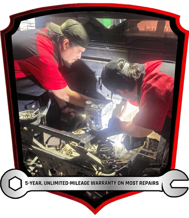 Technicians performing side by side vehicle repair and diagnostic work