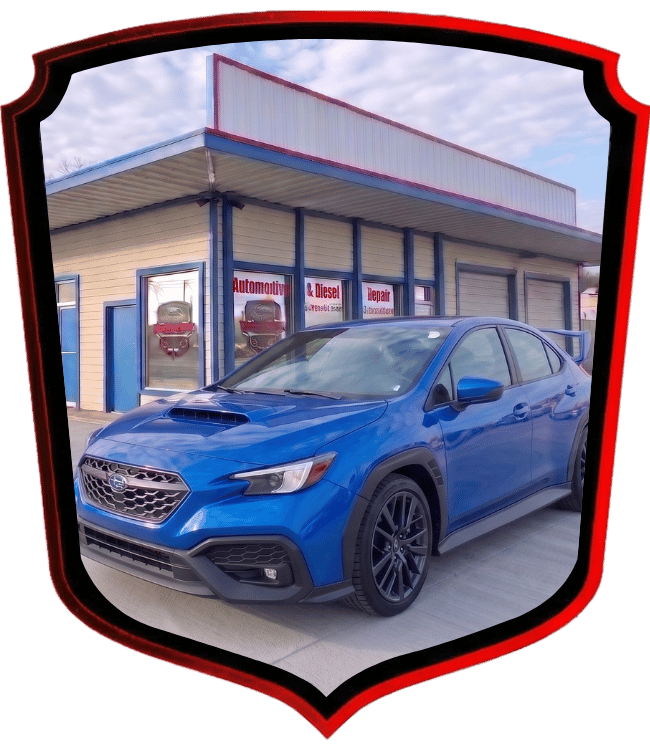 Blue Subaru WRX sedan parked outside WrenchWerks automotive repair shop