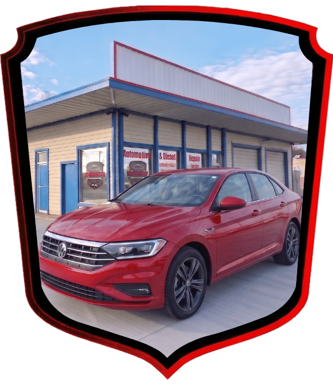 Red Volkswagen Jetta sedan parked outside WrenchWerks automotive shop