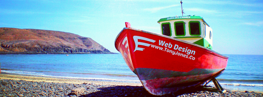 A red and green boat says web design on the side