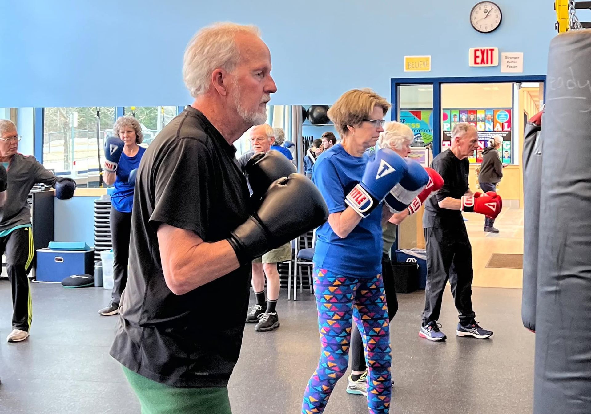 A group of people are boxing in a gym.