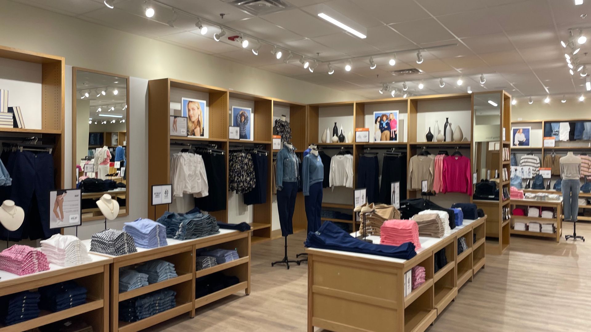 A store filled with lots of clothes and shelves.