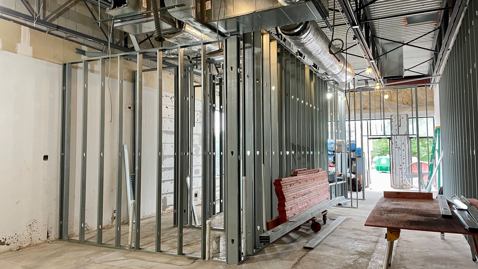 A room under construction with a metal frame and a table.