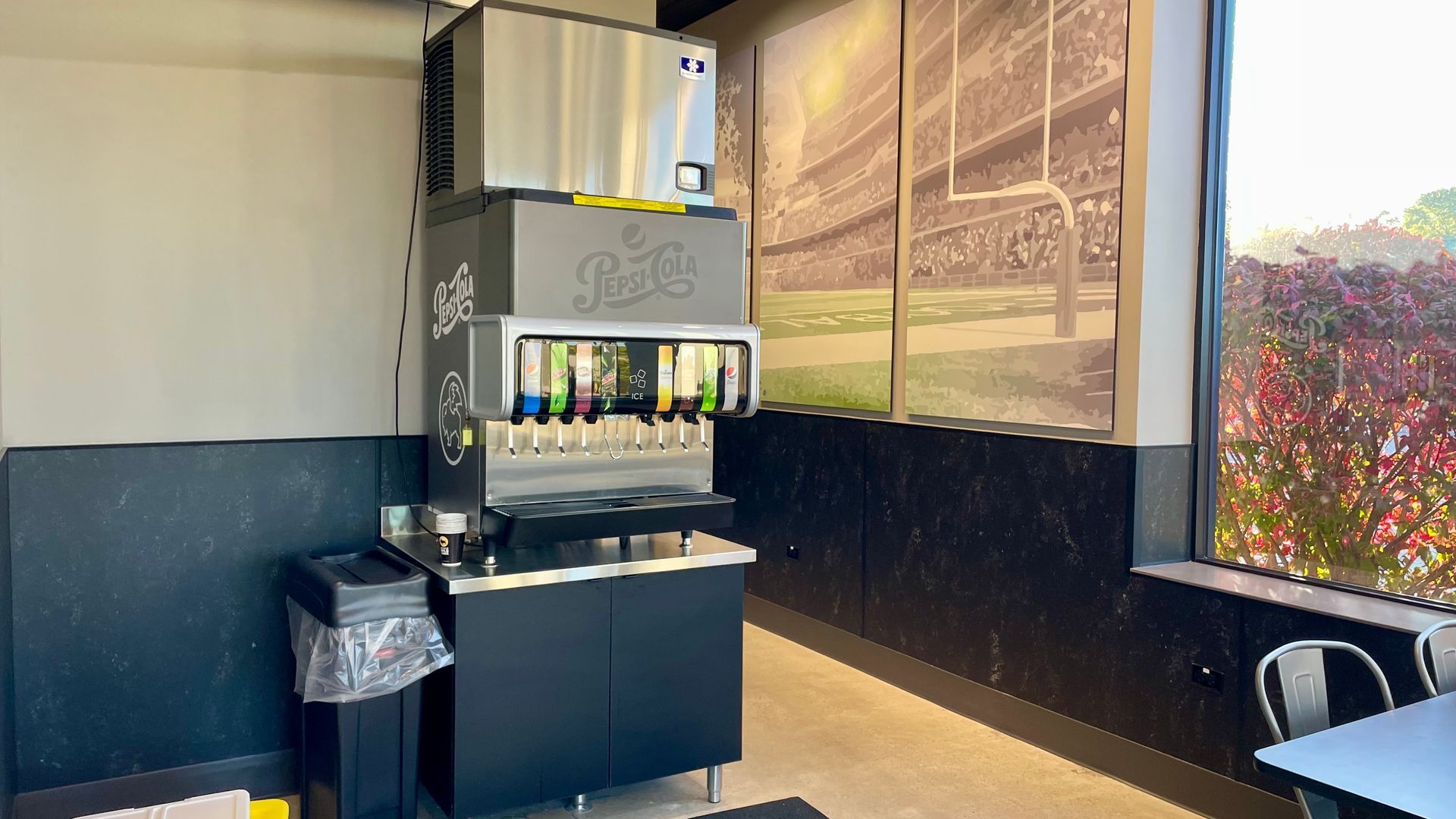 A room with a large ice machine in the middle of it.
