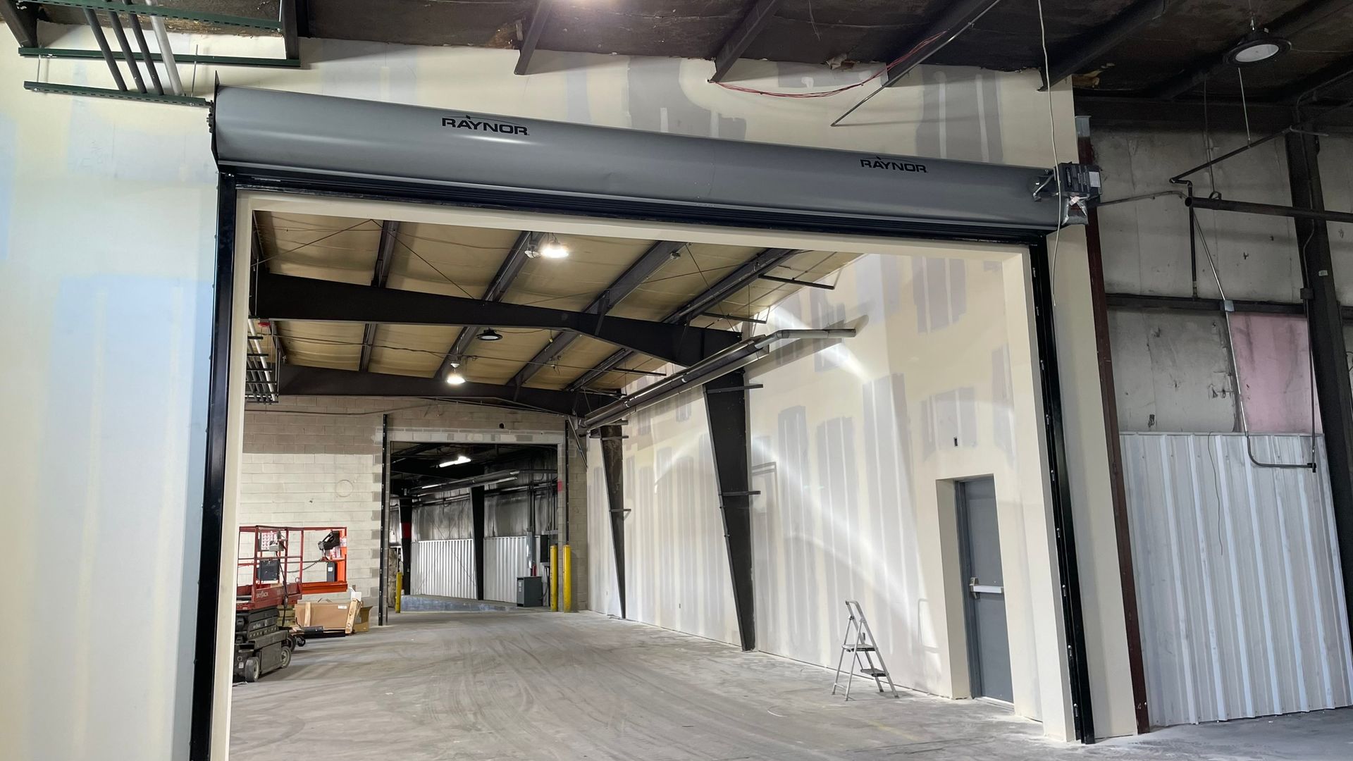 A large warehouse with a sliding door that is open.