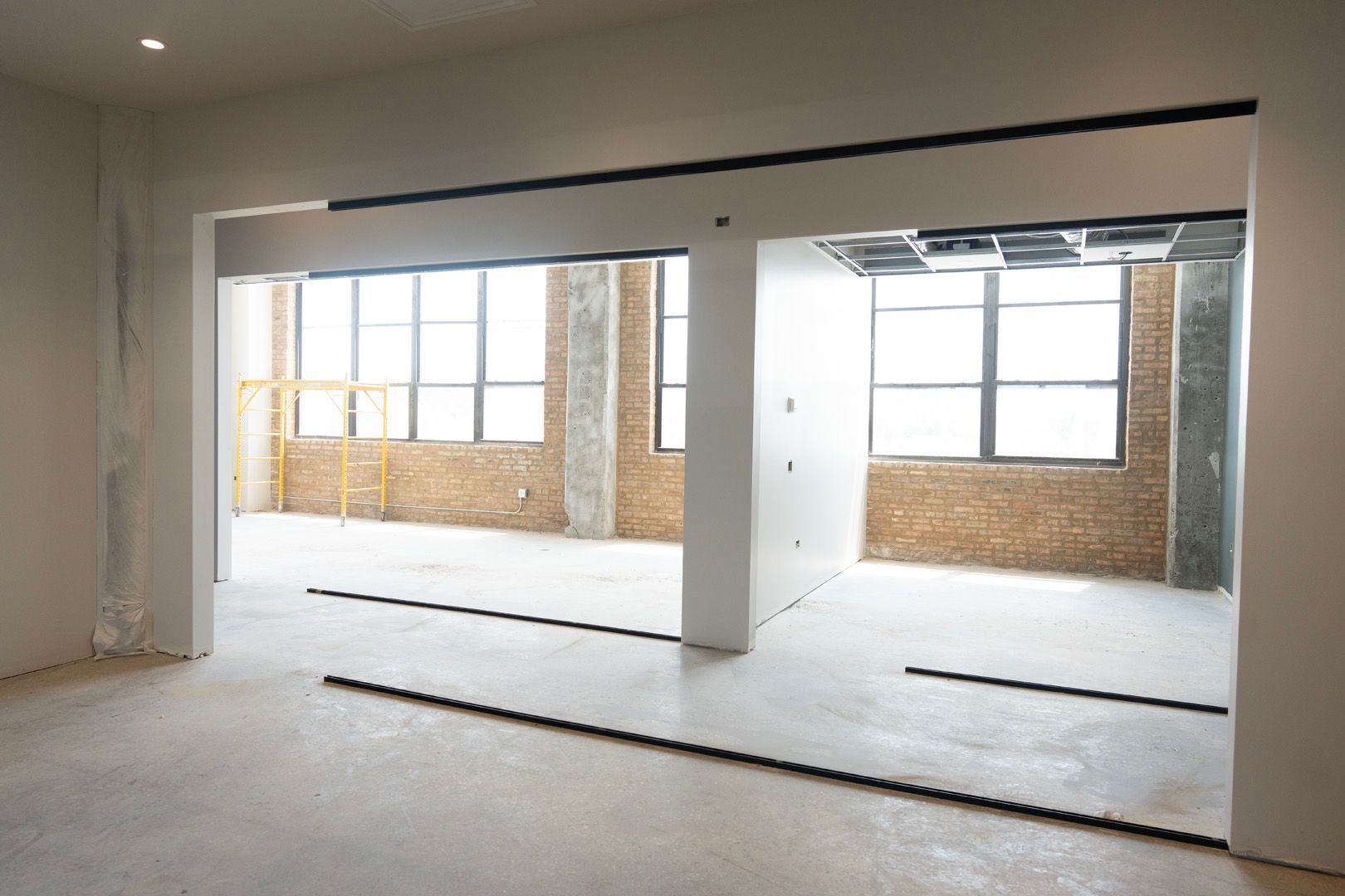 A large empty room with a lot of windows