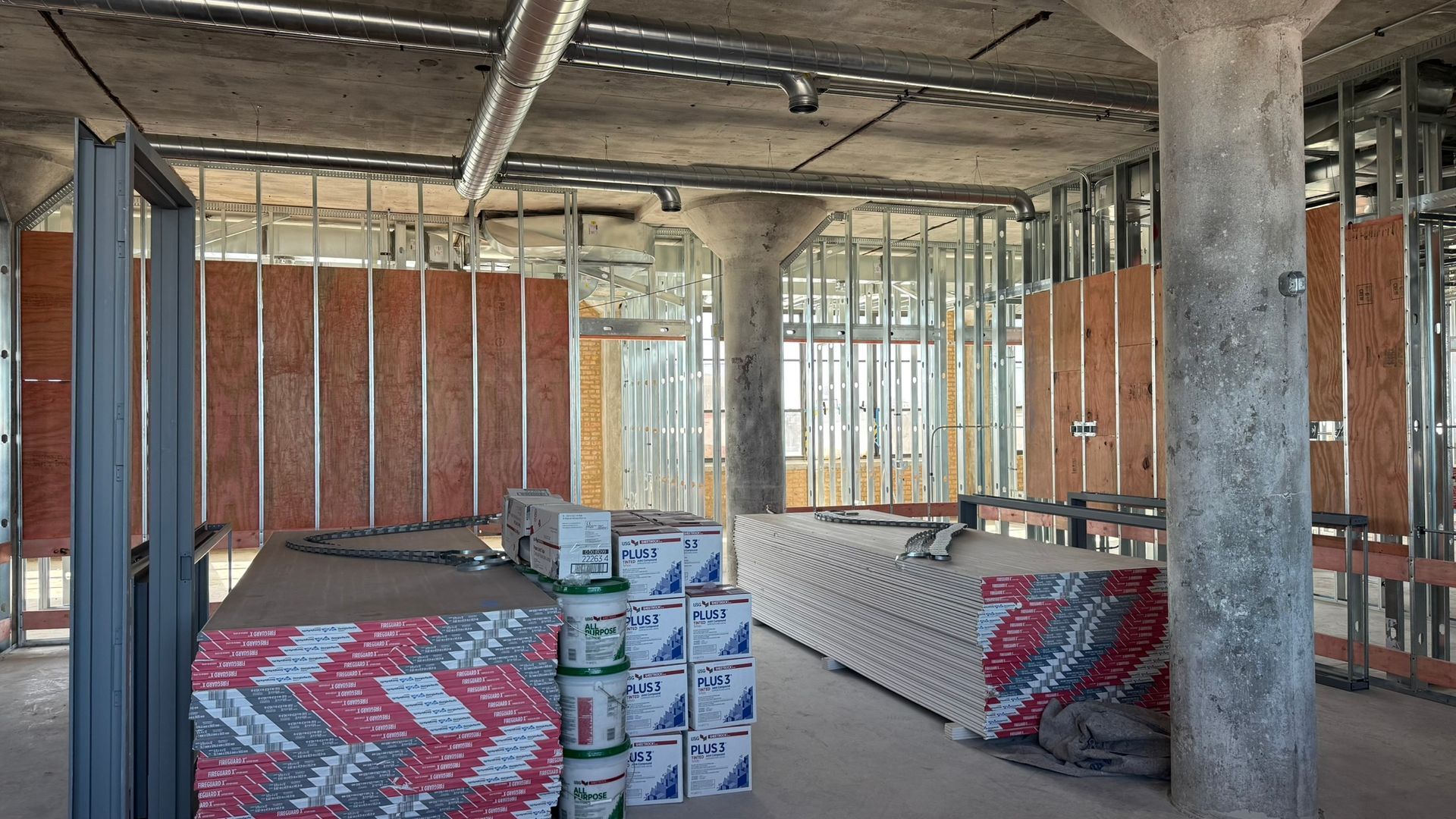 A building under construction with a lot of boxes on the floor.