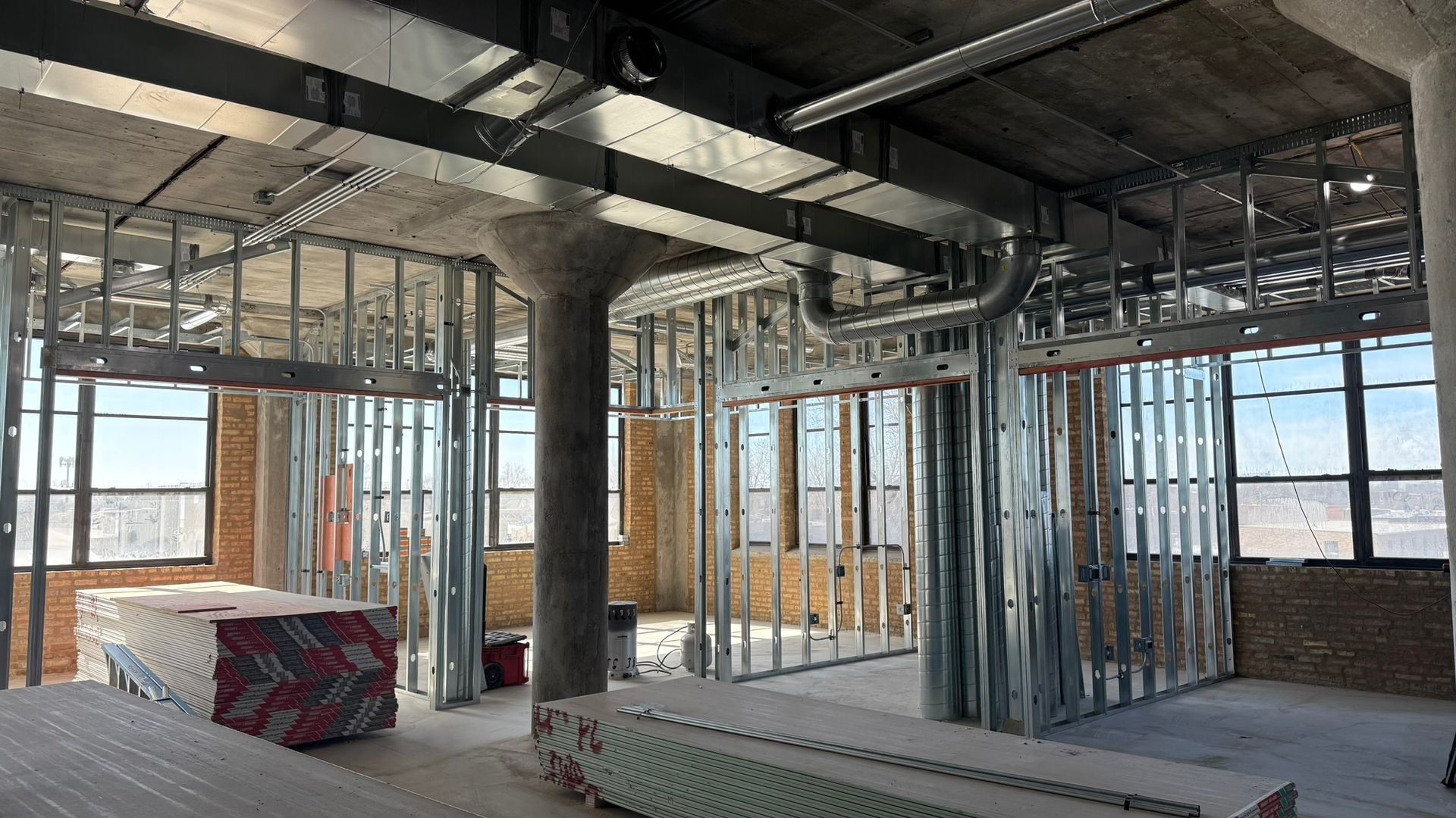 A large room with a lot of windows is being built.