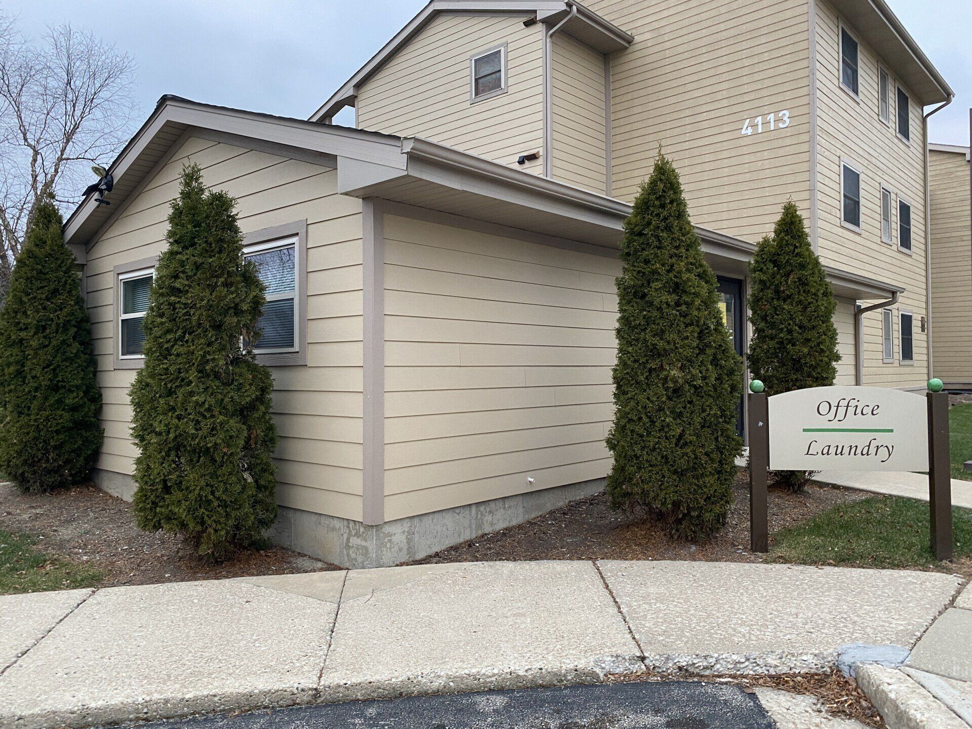 A building with a lot of windows and trees in front of it
