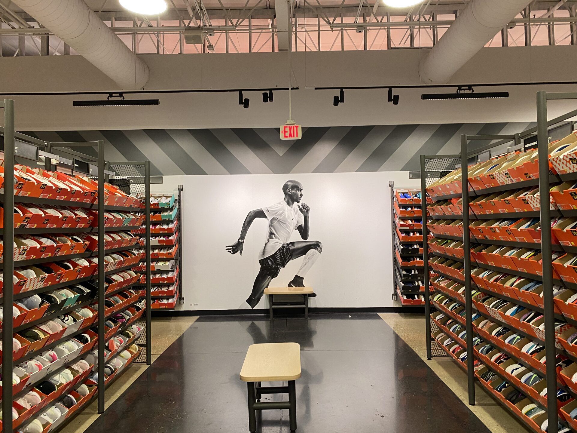 A picture of a man running in a nike store