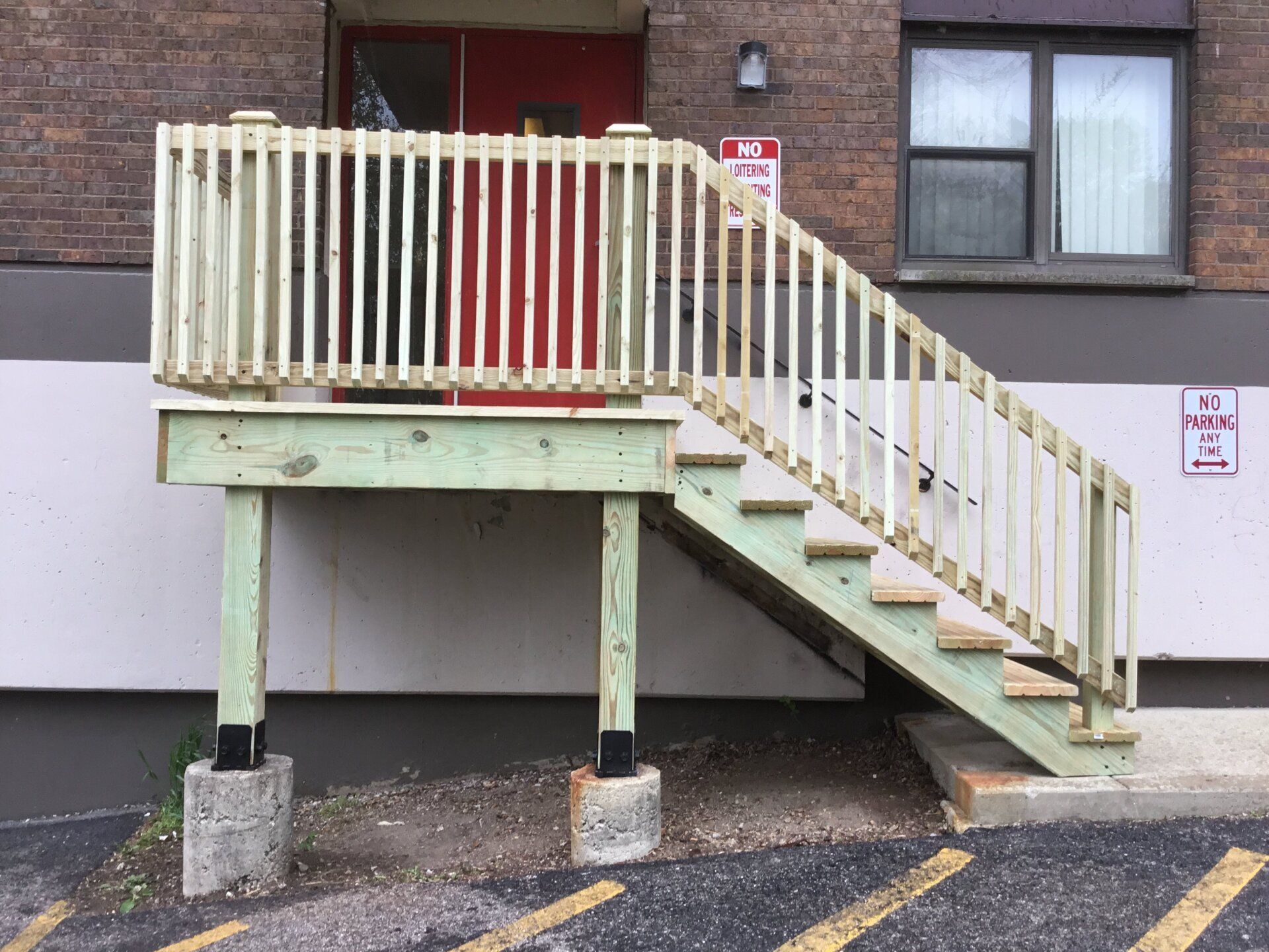 A wooden deck with stairs leading up to a building