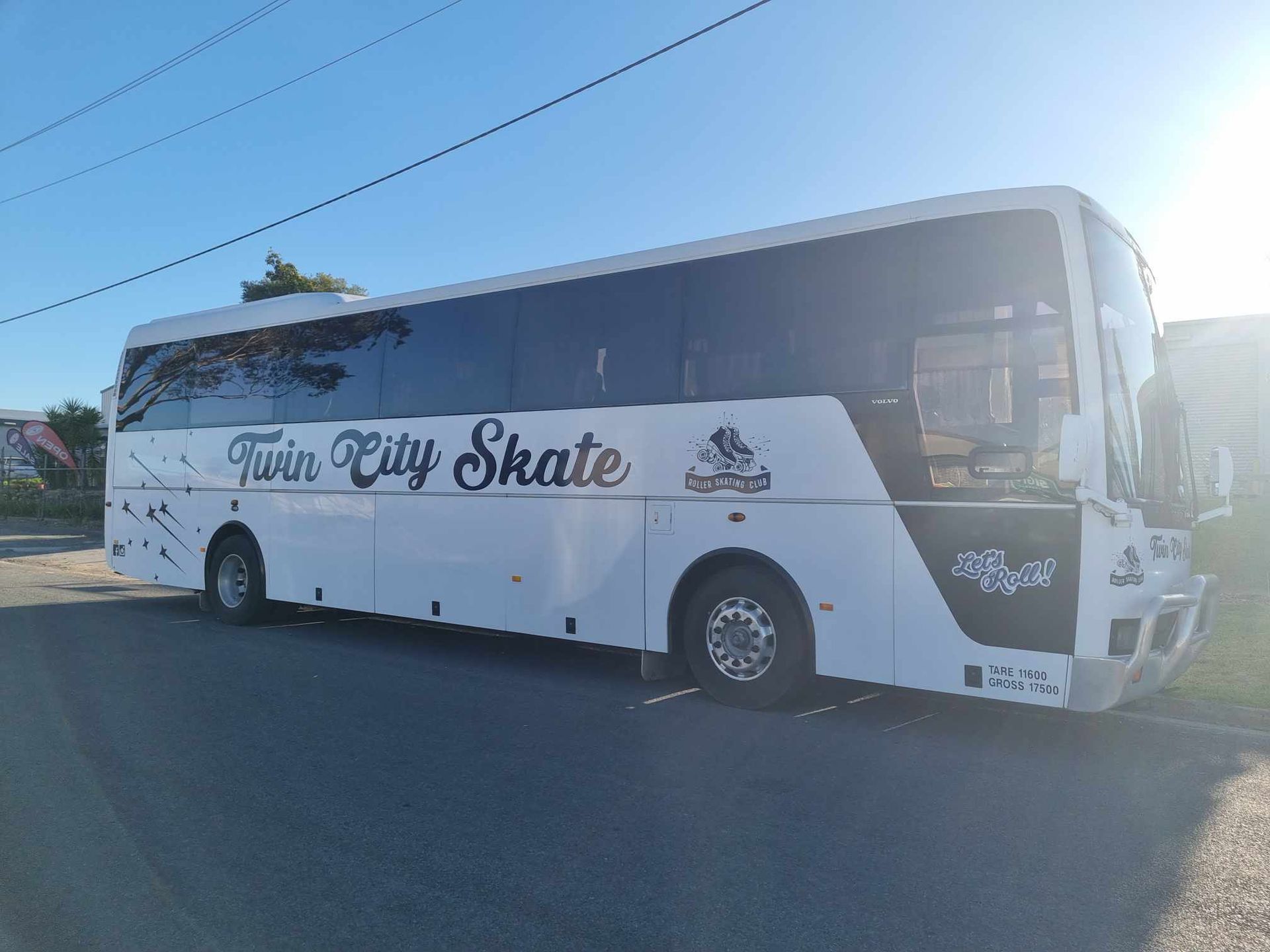 A White Bus is Parked on the Side of the Road — Robinsons Sign Makers in Lavington, NSW