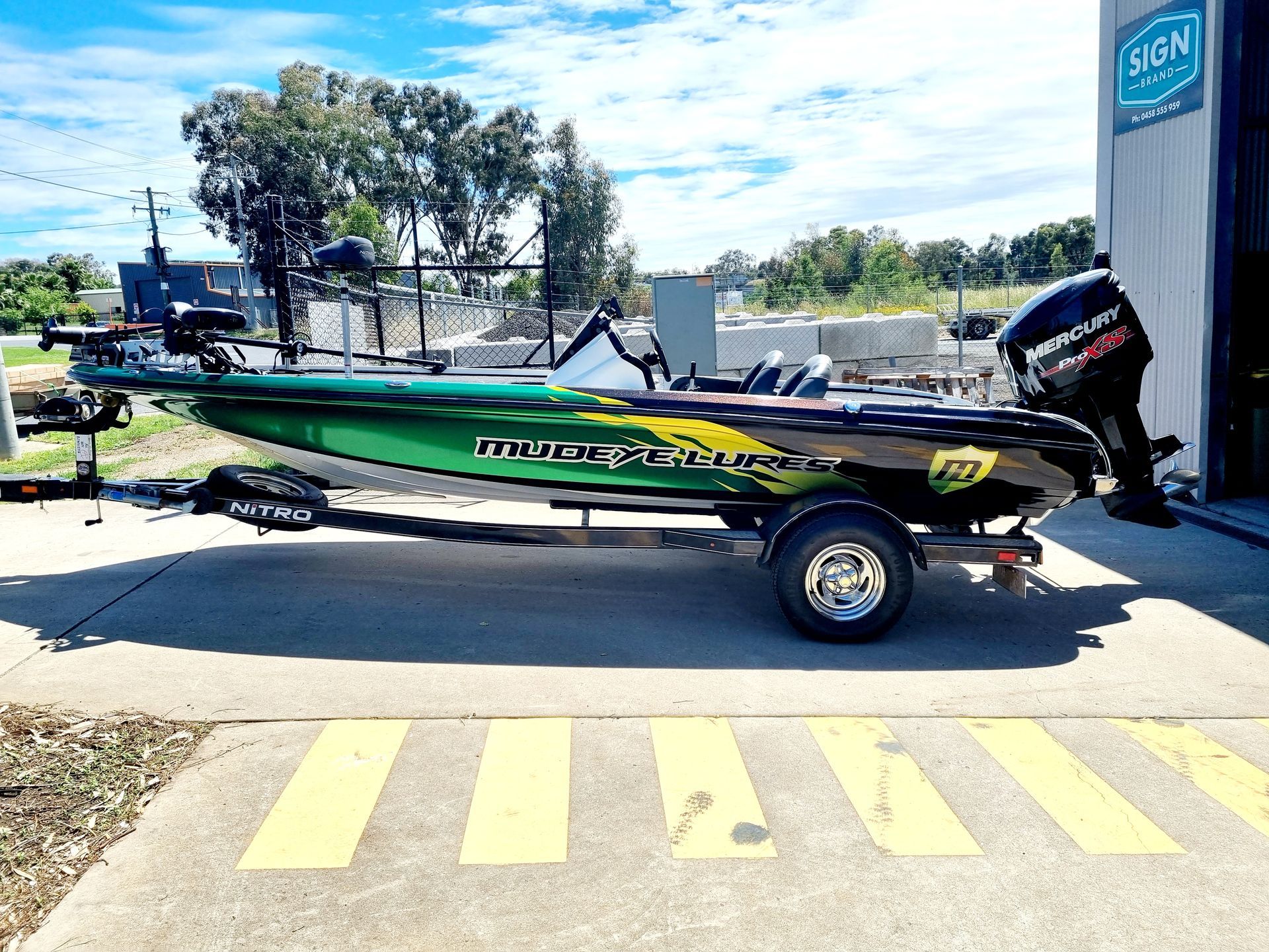 A Green and Black Fishing Boat is Parked in a Parking Lot — Robinsons Sign Makers in Lavington, NSW