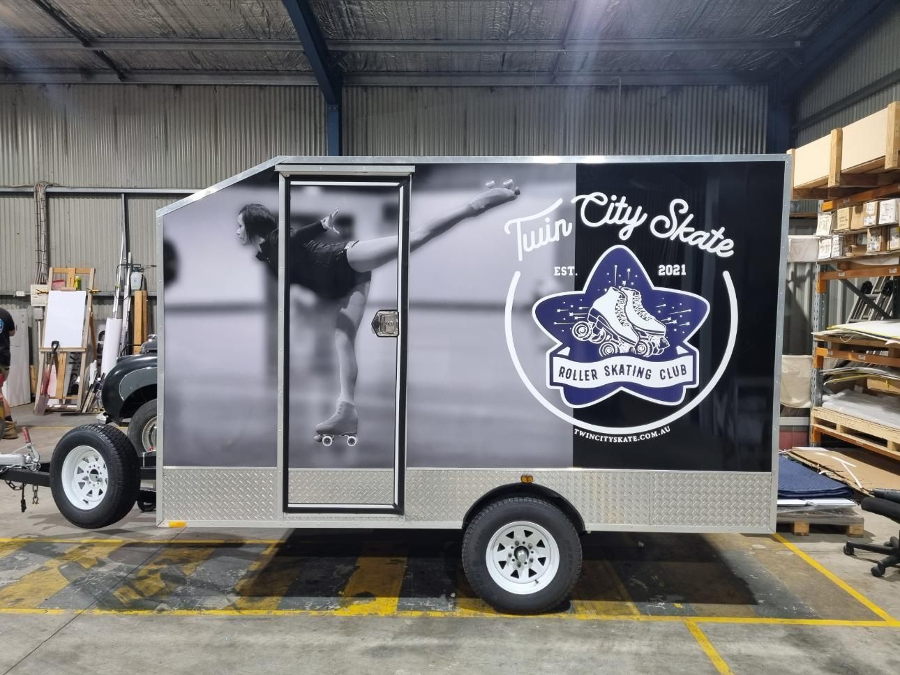 A Black and White Truck is Parked on the Side of the Road with Vehicle Wrap — Robinsons Sign Makers in Lavington, NSW