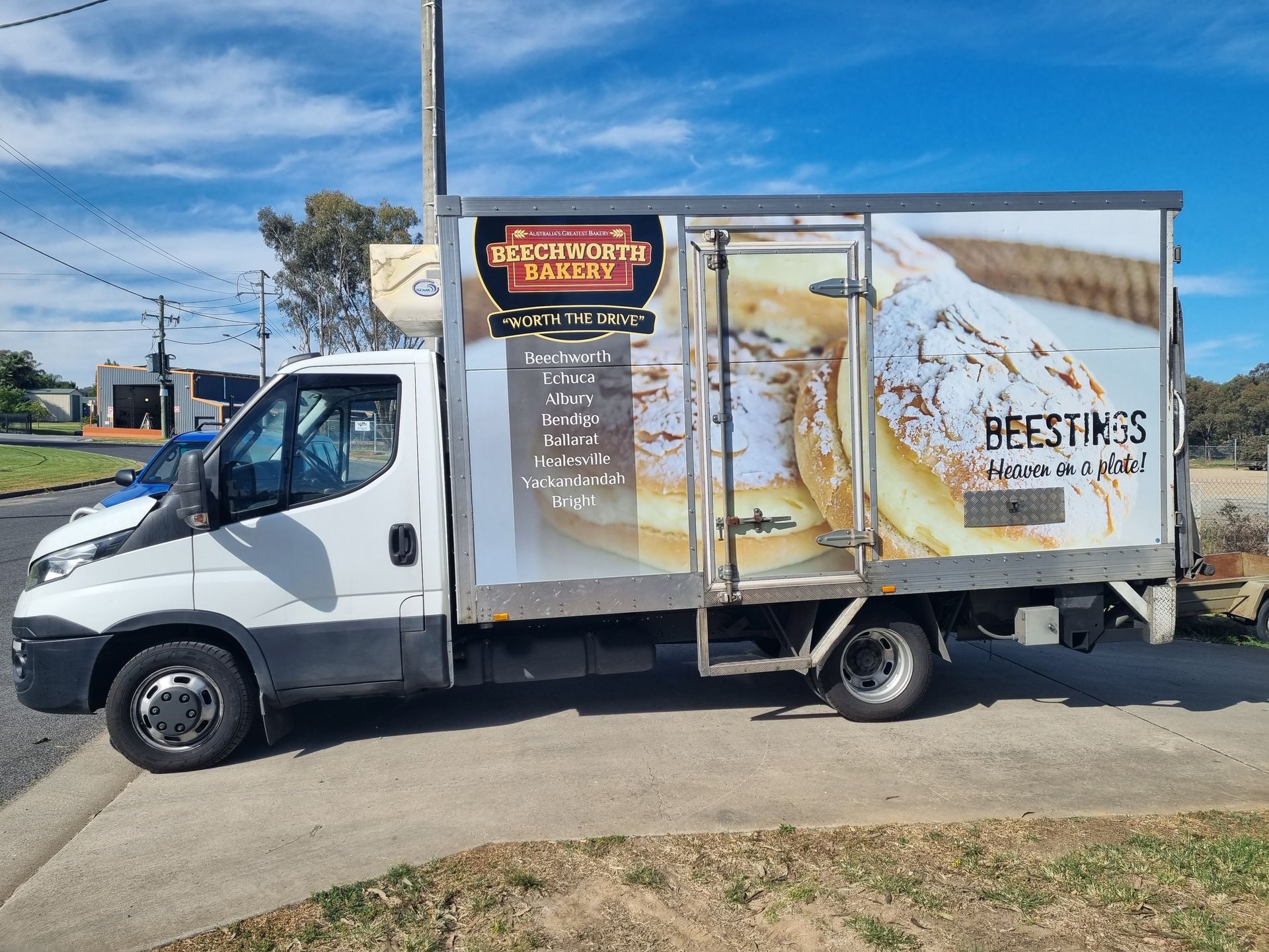 A White Truck is Parked on the Side of the Road — Robinsons Sign Makers in Lavington, NSW