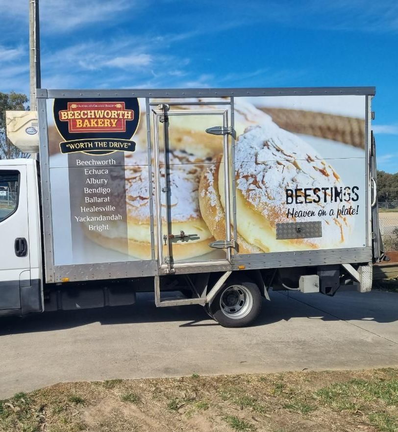 A White Truck is Parked on the Side of the Road — Robinsons Sign Makers in Lavington, NSW