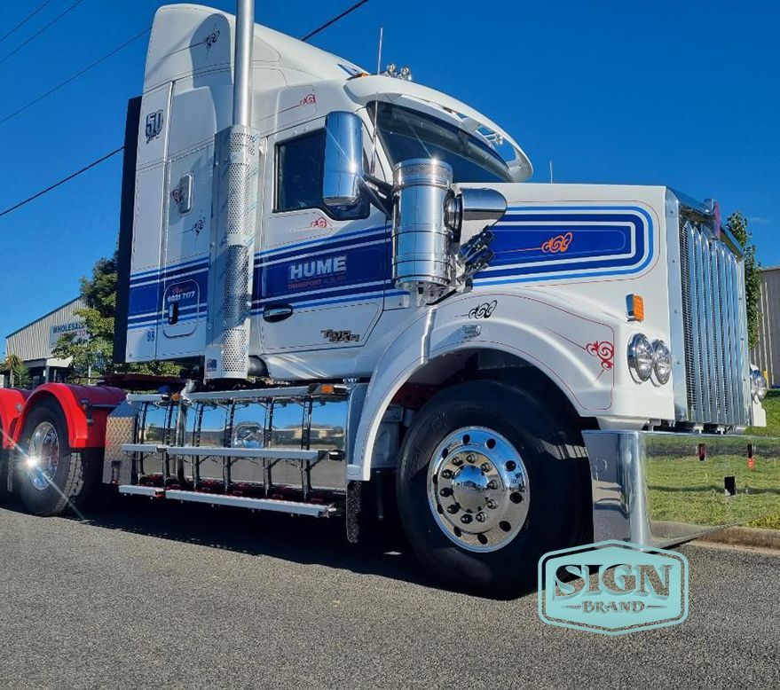 A White Semi Truck With a Red Trailer is Parked on the Side of the Road — Robinsons Sign Makers in Lavington, NSW
