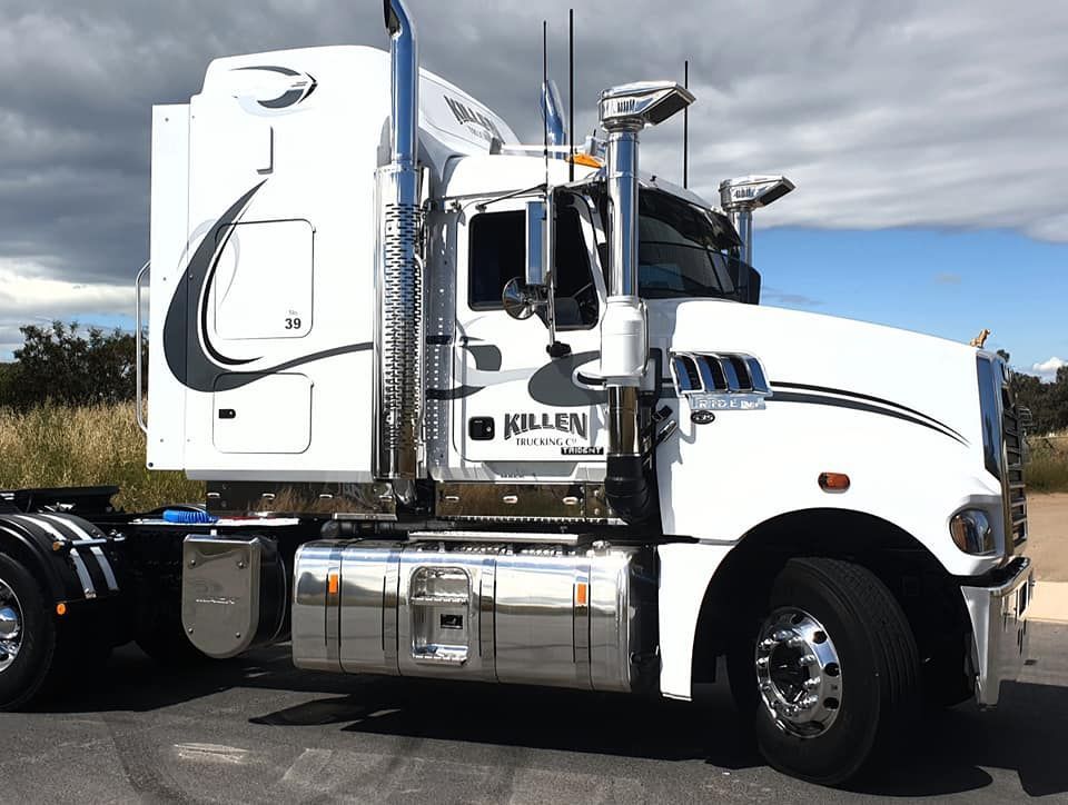A White Semi Truck is Parked on the Side of the Road — Robinsons Sign Makers in Lavington, NSW