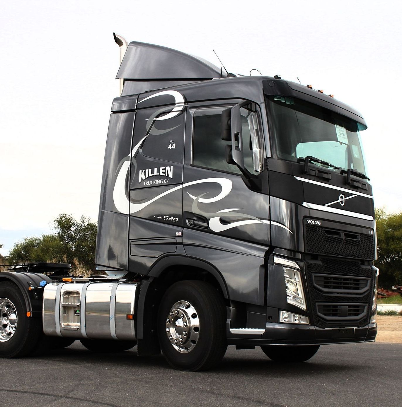 A White Semi Truck With a Red Trailer is Parked on the Side of the Road — Robinsons Sign Makers in Lavington, NSW