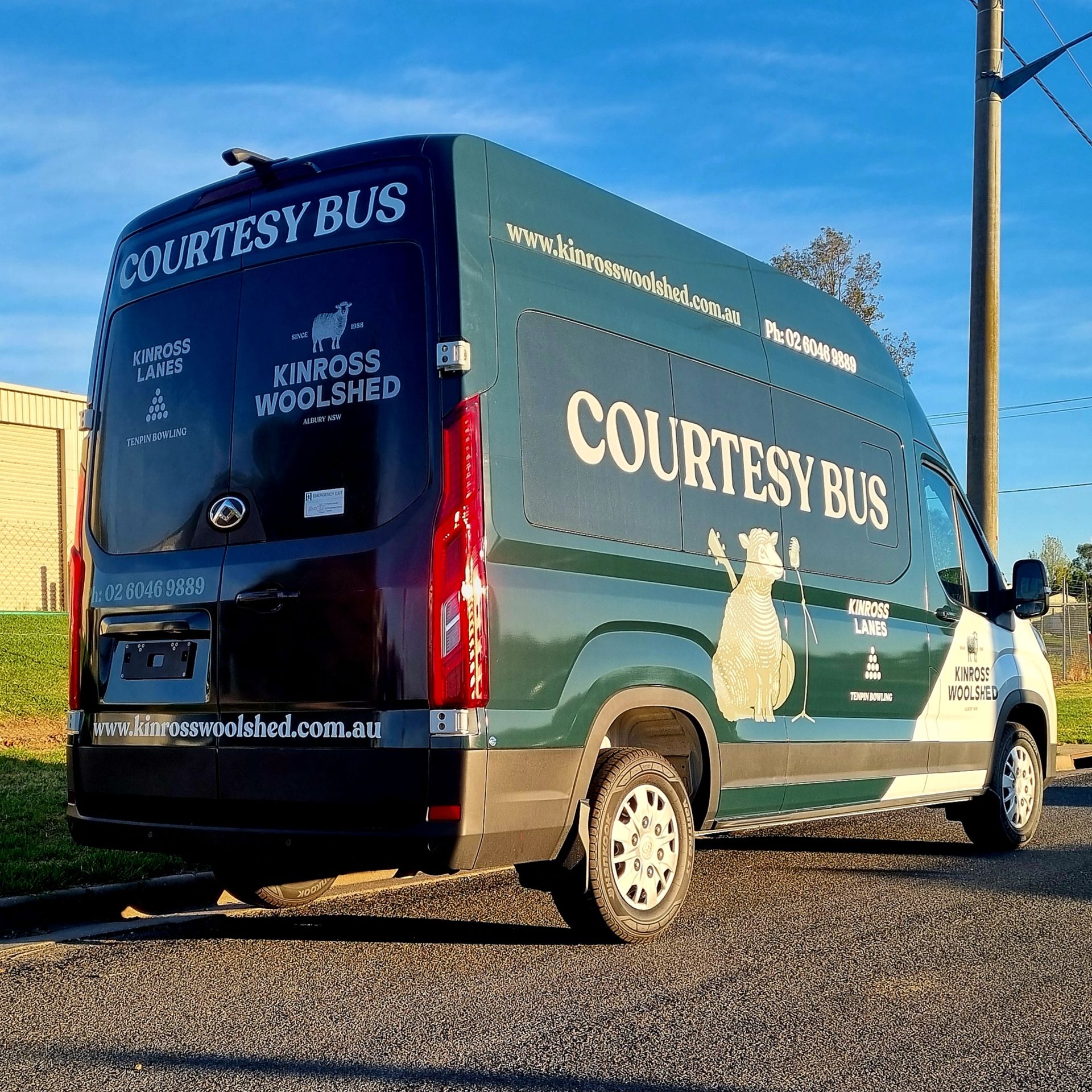 A Green Courtesy Bus Van is Parked on the Side of the Road — Robinsons Sign Makers in Lavington, NSW