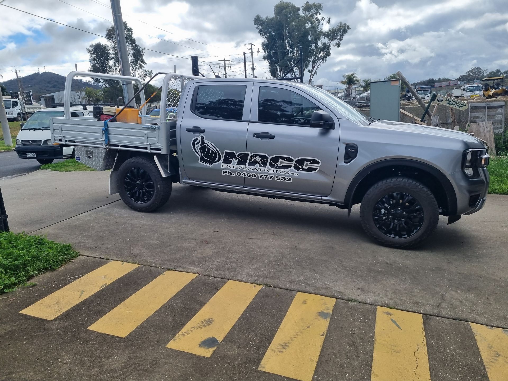 A Silver Truck is Parked in a Parking Lot Next to a Yellow Stripe — Robinsons Sign Makers in Lavington, NSW