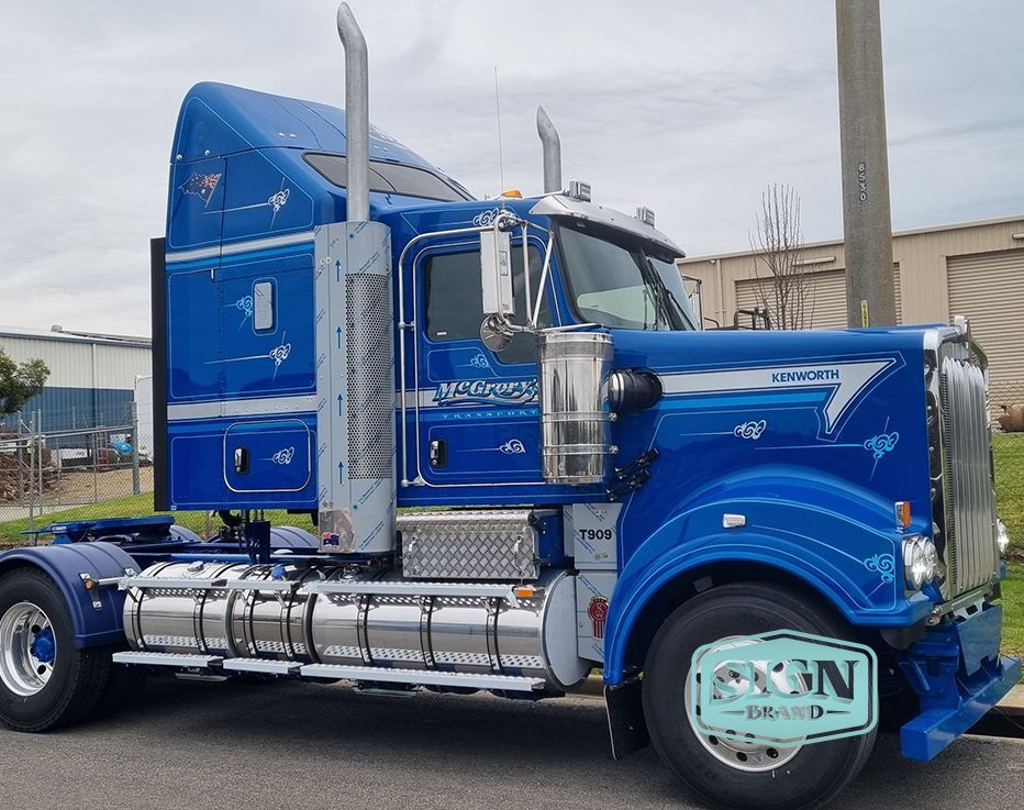 A Blue Semi Truck is Parked on the Side of the Road — Robinsons Sign Makers in Lavington, NSW