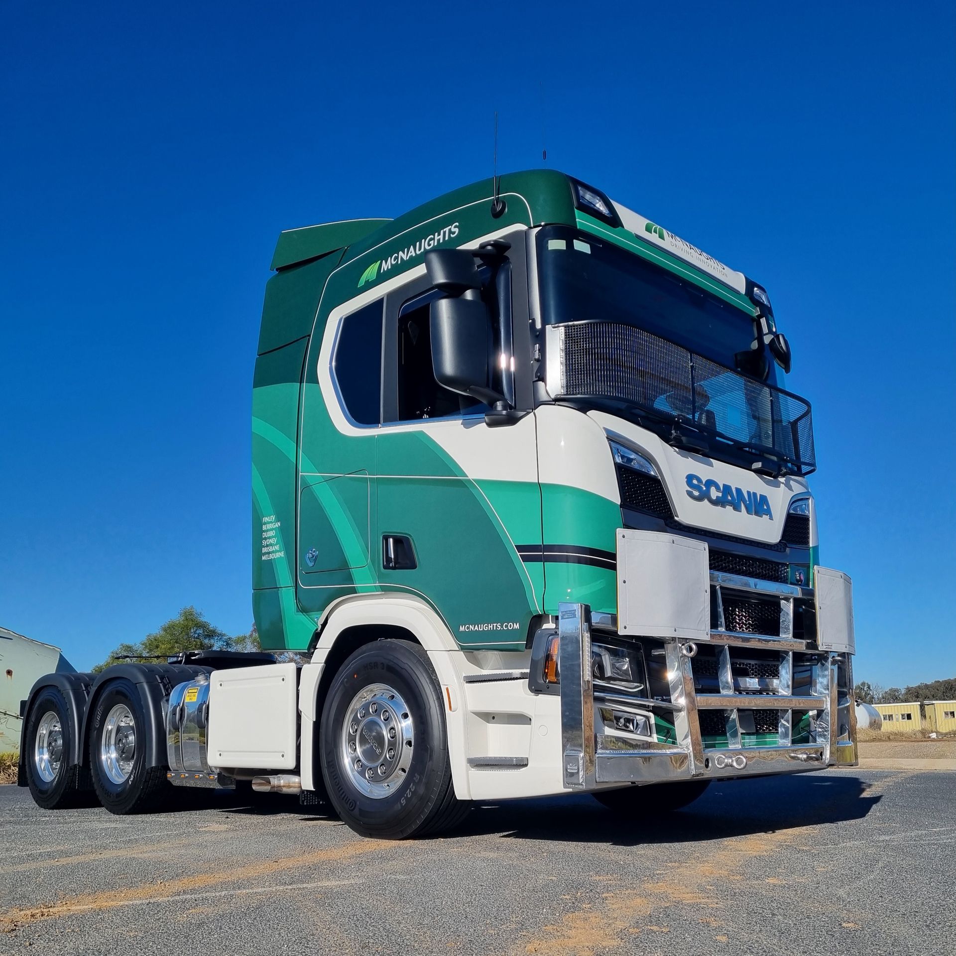 A Green Truck With the Word McNaughts on the Side is Parked in a Parking Lot — Robinsons Sign Makers in Lavington, NSW