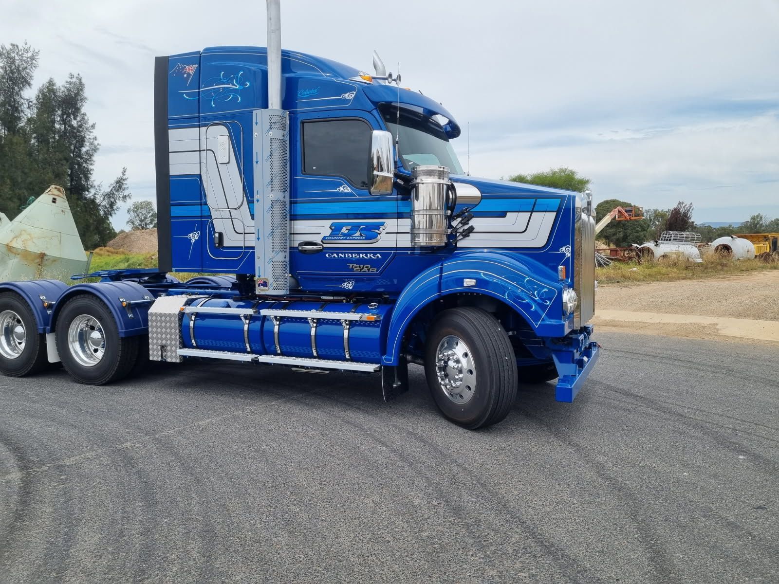 A Blue Semi Truck is Turning into the Road — Robinsons Sign Makers in Canberra, ACT
