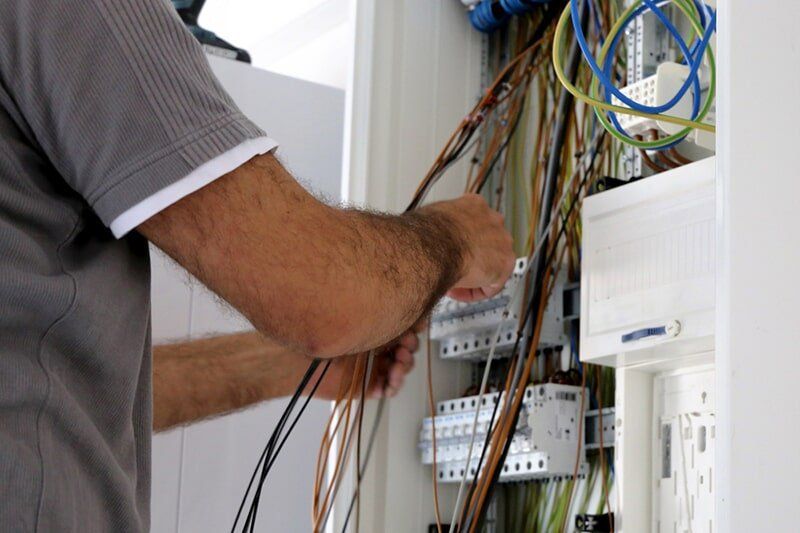 Electrician Checking Electric Wires — Reef Electrical in Cannonvale, QLD