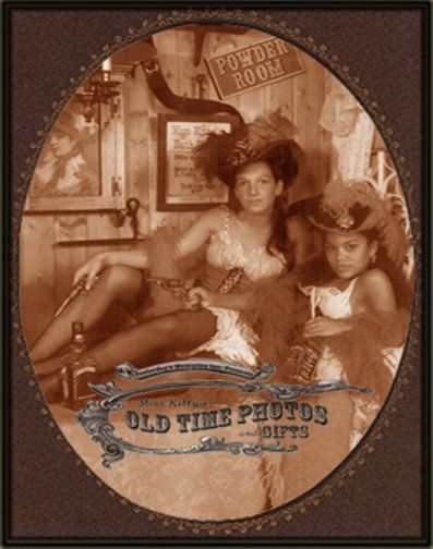 Two girls dressed as barmaids for and old time photo
