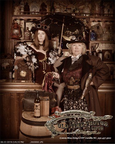 two women in steampunk costumes are posing for a - Miss Kitty's Old Time Photos and Gifts    Corolla Outer Banks NC
