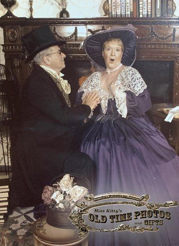 a man in a top hat and a woman in a purple dress are posing for an old time photo
