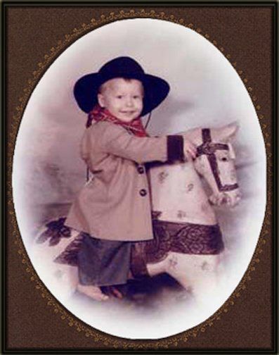 a little boy in a cowboy hat is riding a rocking horse