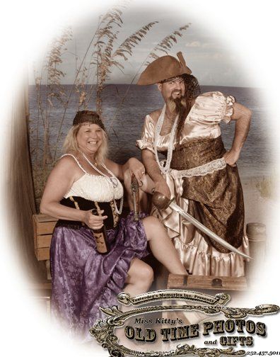 a man and a woman dressed as pirates pose for a photo