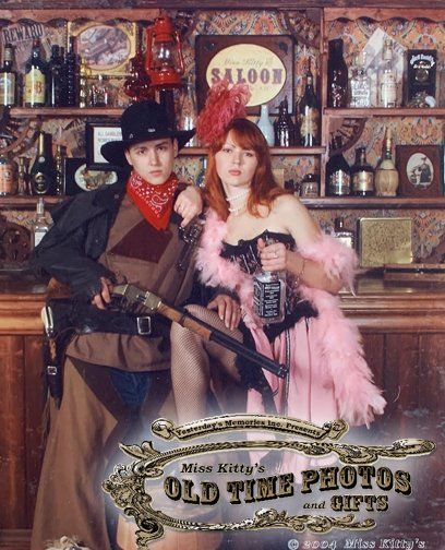 a man and a woman pose in front of a saloon sign - Miss Kitty's Old Time Photos and Gifts    Corolla Outer Banks NC