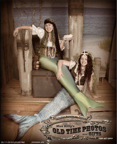 two women dressed as mermaids are posing for a old time picture - Miss Old Time Photos and Gifts    Corolla Outer Banks NC .