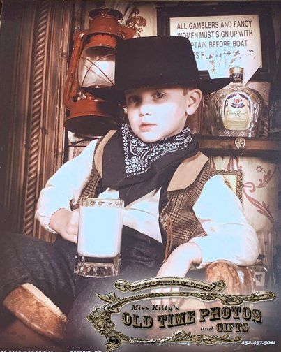 a young boy in a cowboy outfit is holding a glass of milk Miss Old Time Photos and Gifts    Corolla Outer Banks NC