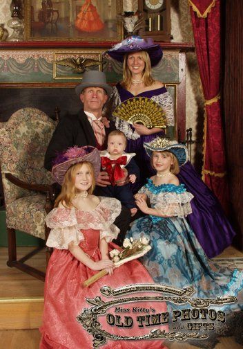a family posing for a picture in old time costumes