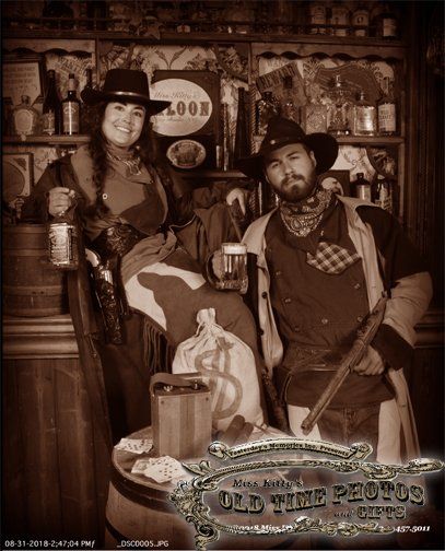 a man and a woman are posing for a picture in a old time photo